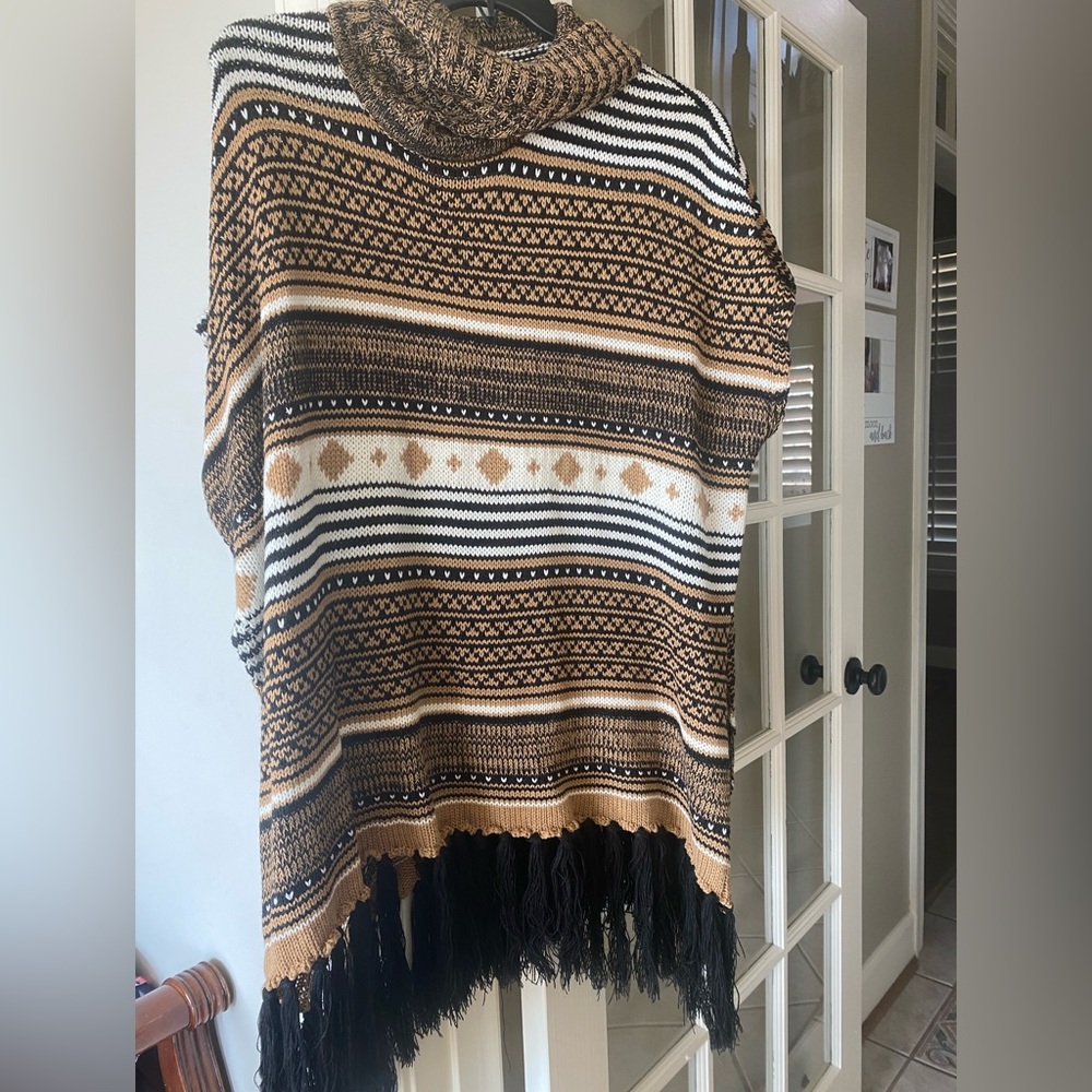 Cozy turtleneck boho print poncho sweater with black fringe one size
Cal Style